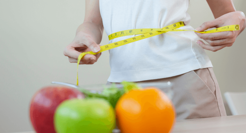 woman-measures-her-waist-size-with-tape-measure-wi-2023-11-27-04-51-55-utc (1)